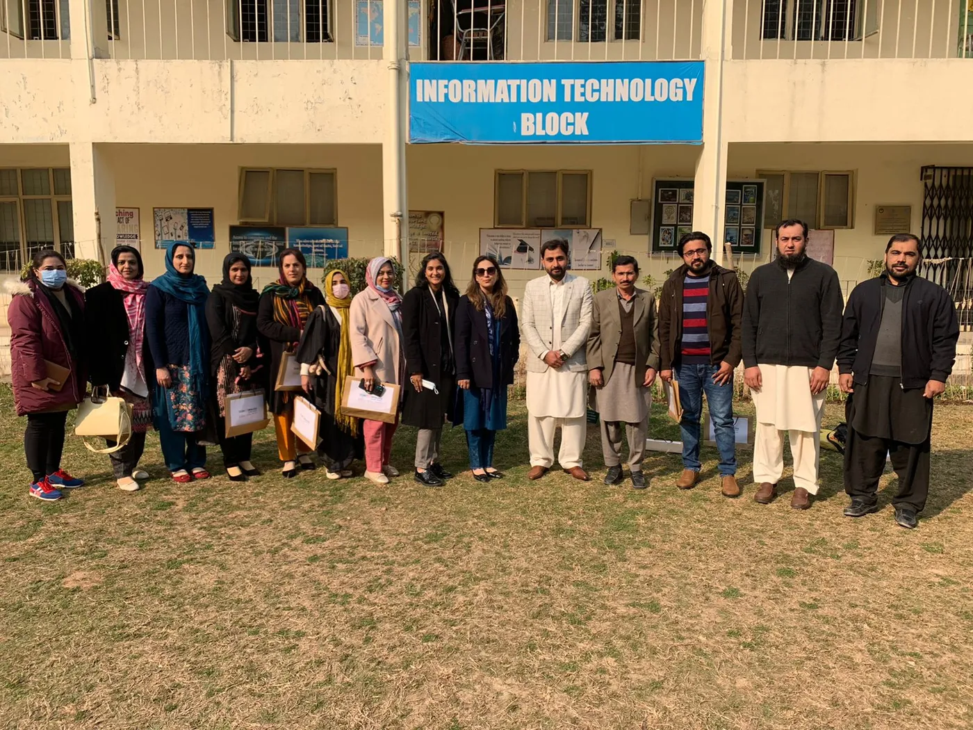 Teachers and trainers outside a school information technology block