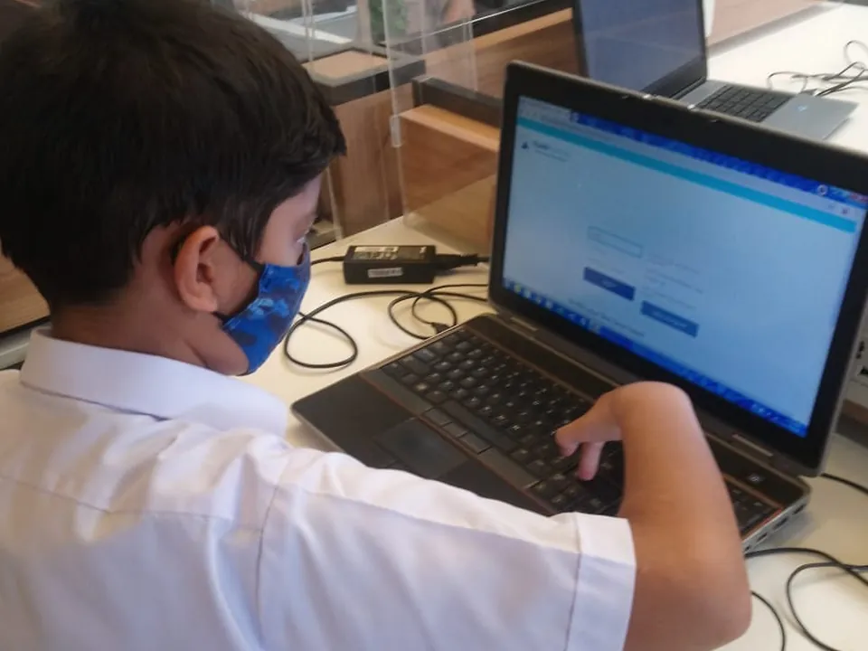 A student taking a live online coding class on a laptop