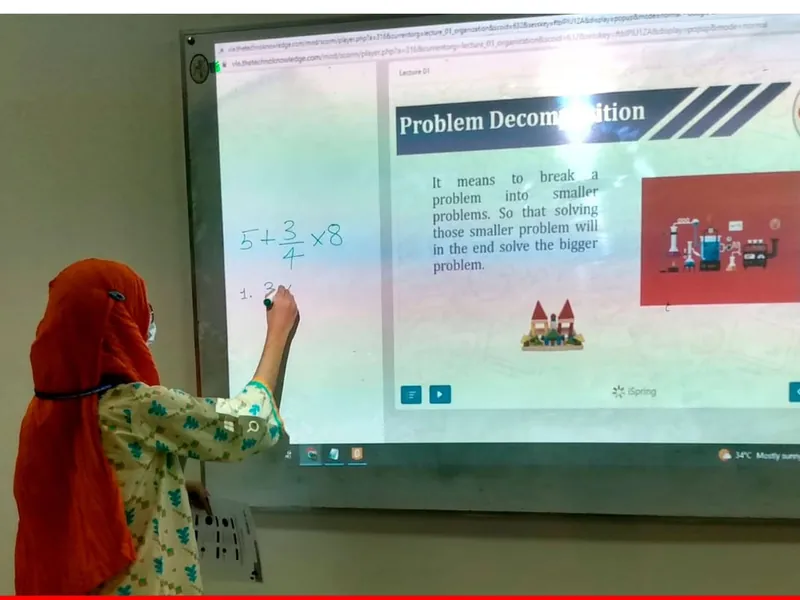 A student solving a problem on the interactive board