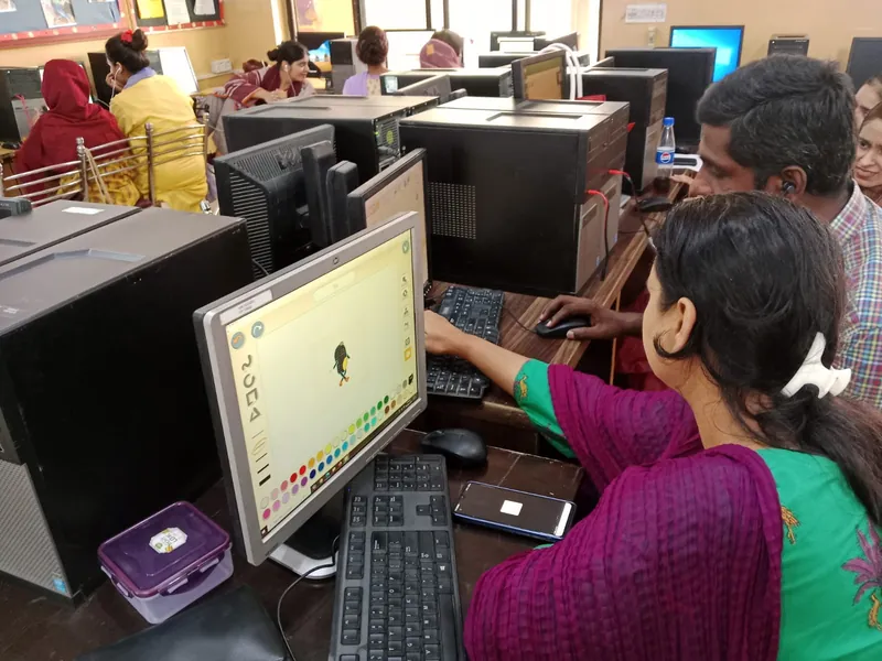 Teachers practising coding on desktop computers