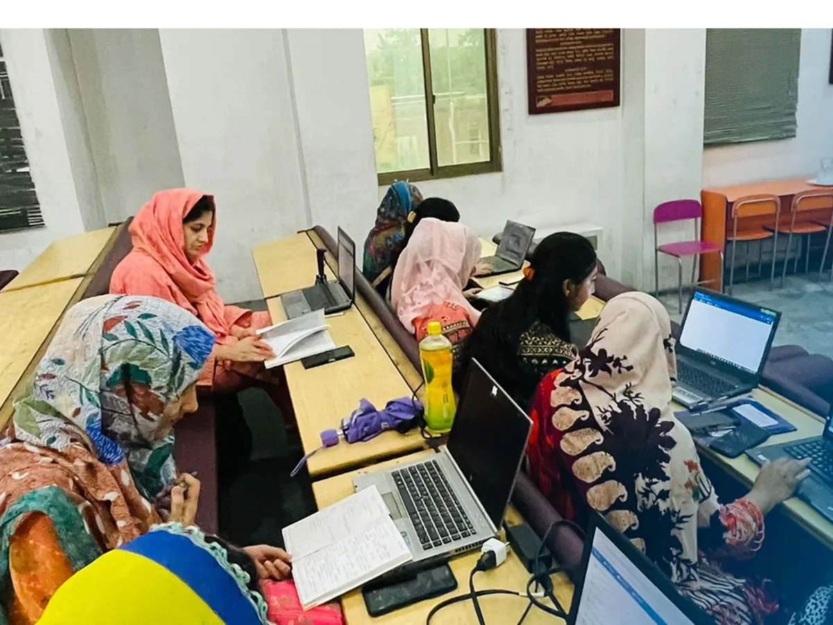Teachers using laptops to prepare materials with AI