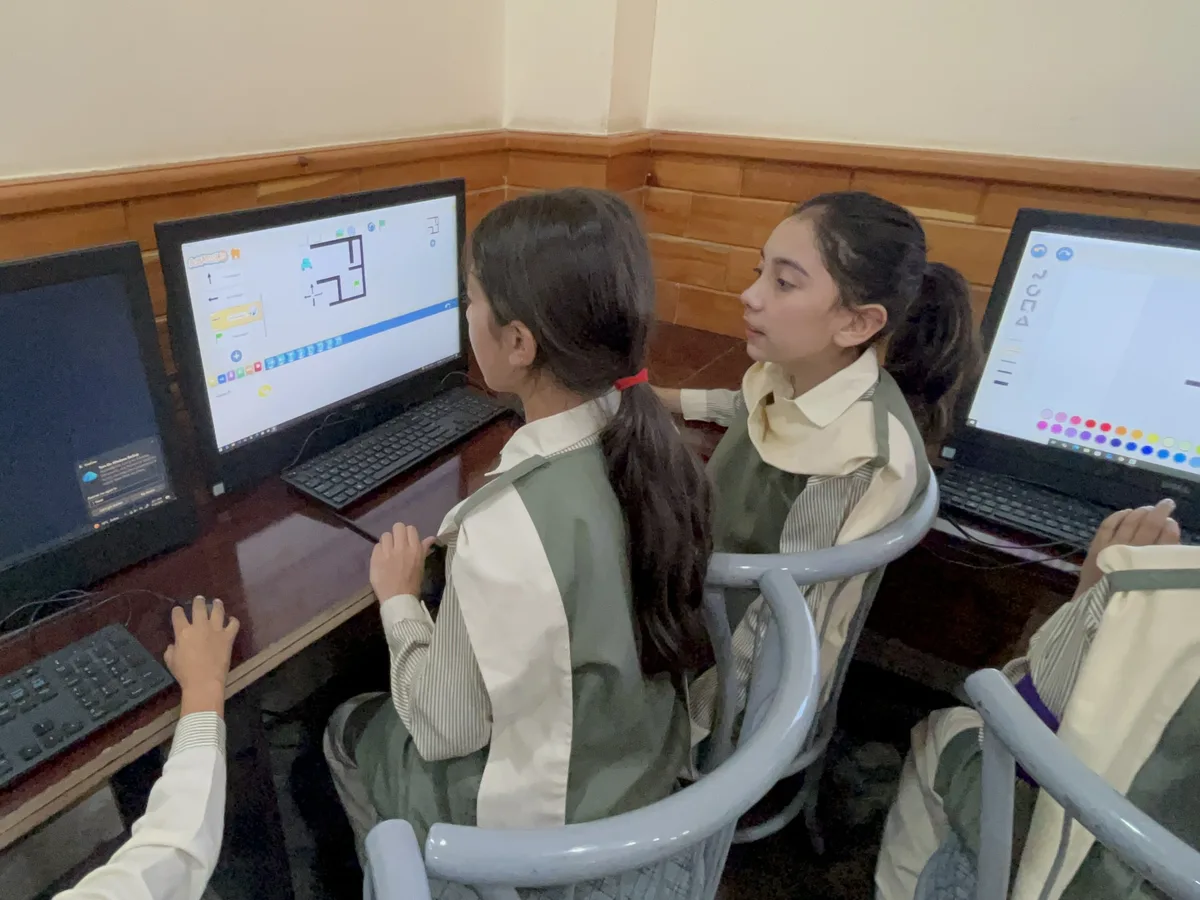 Students coding on desktop computers during an ITEC class