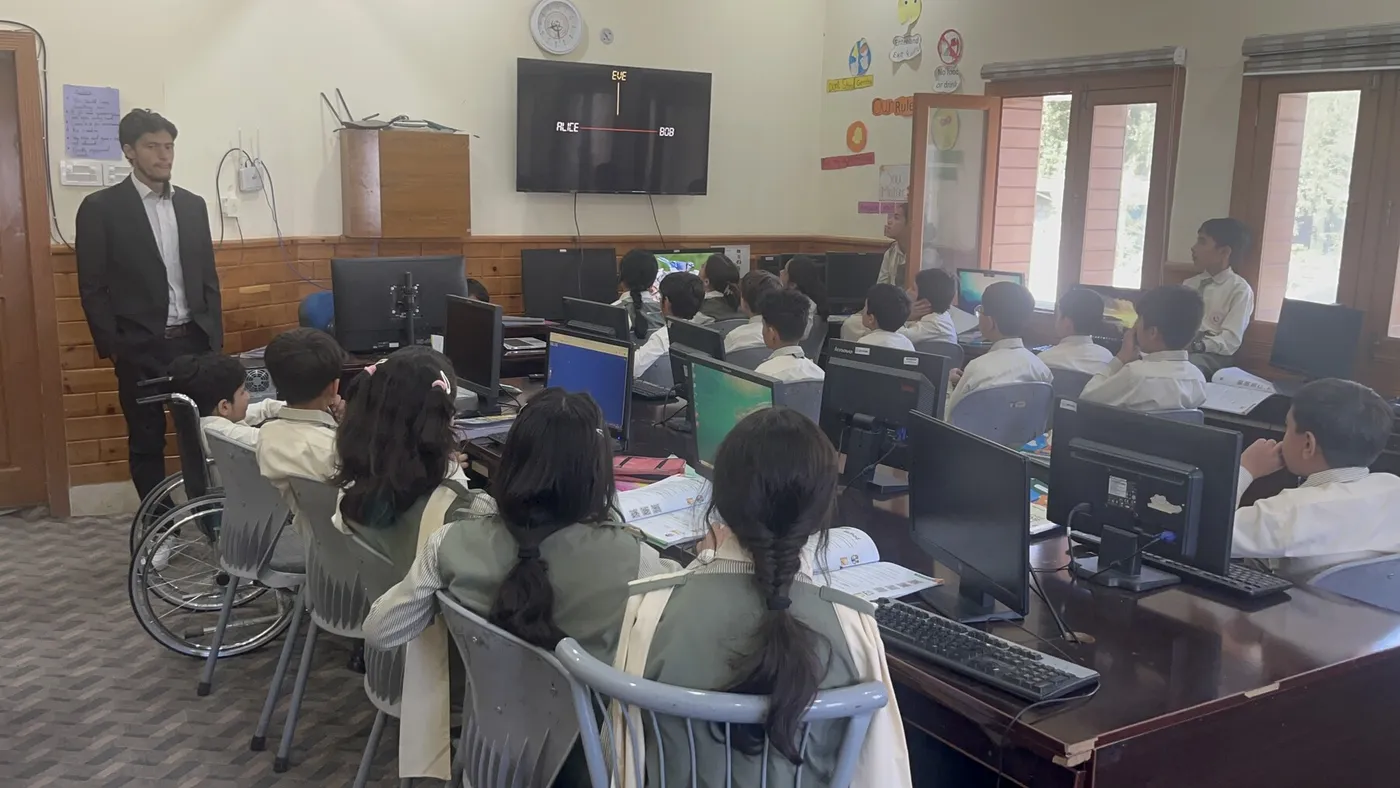 School staff observing students during a computer class
