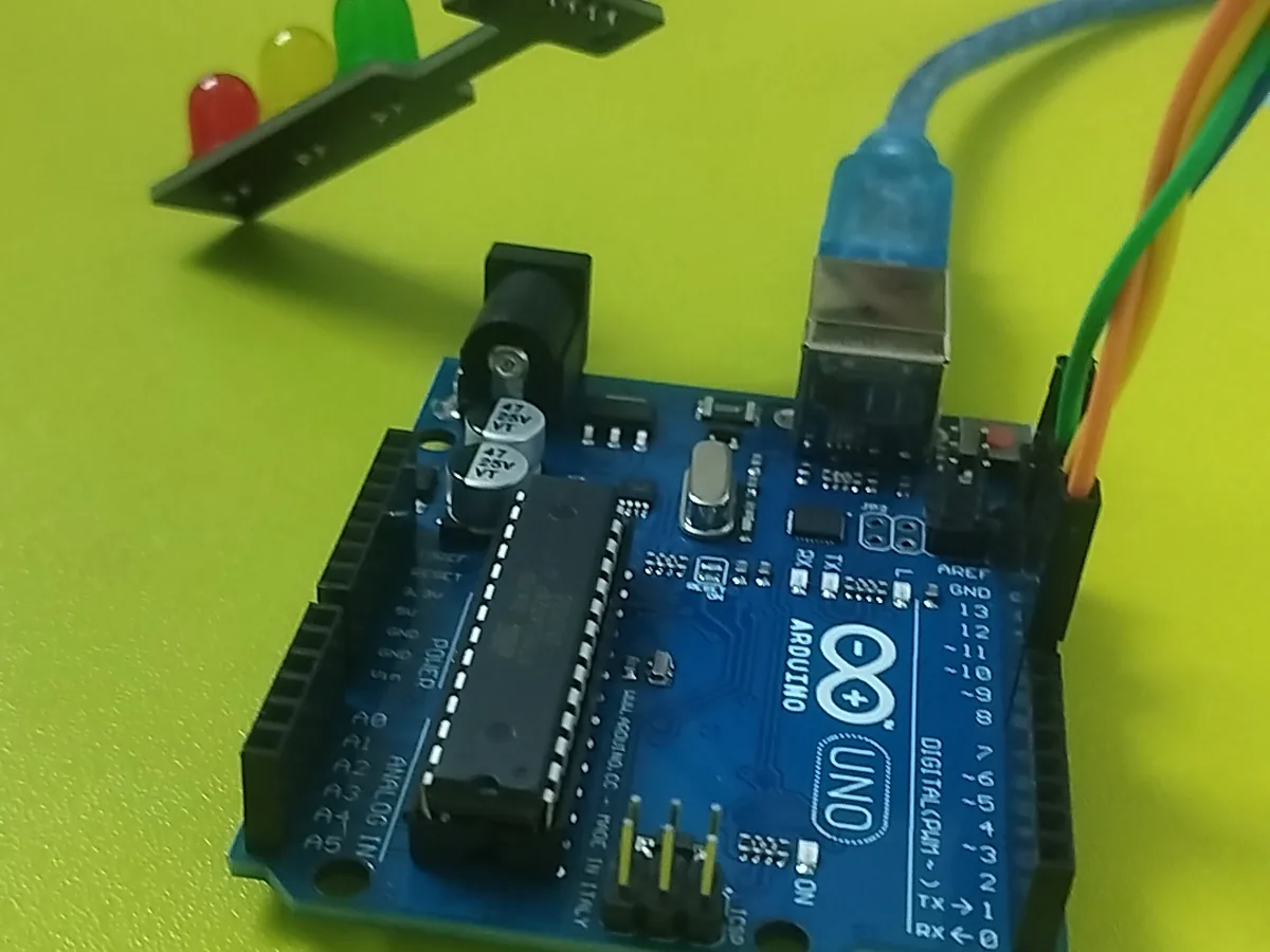 An Arduino Uno wired to a traffic-light LED module