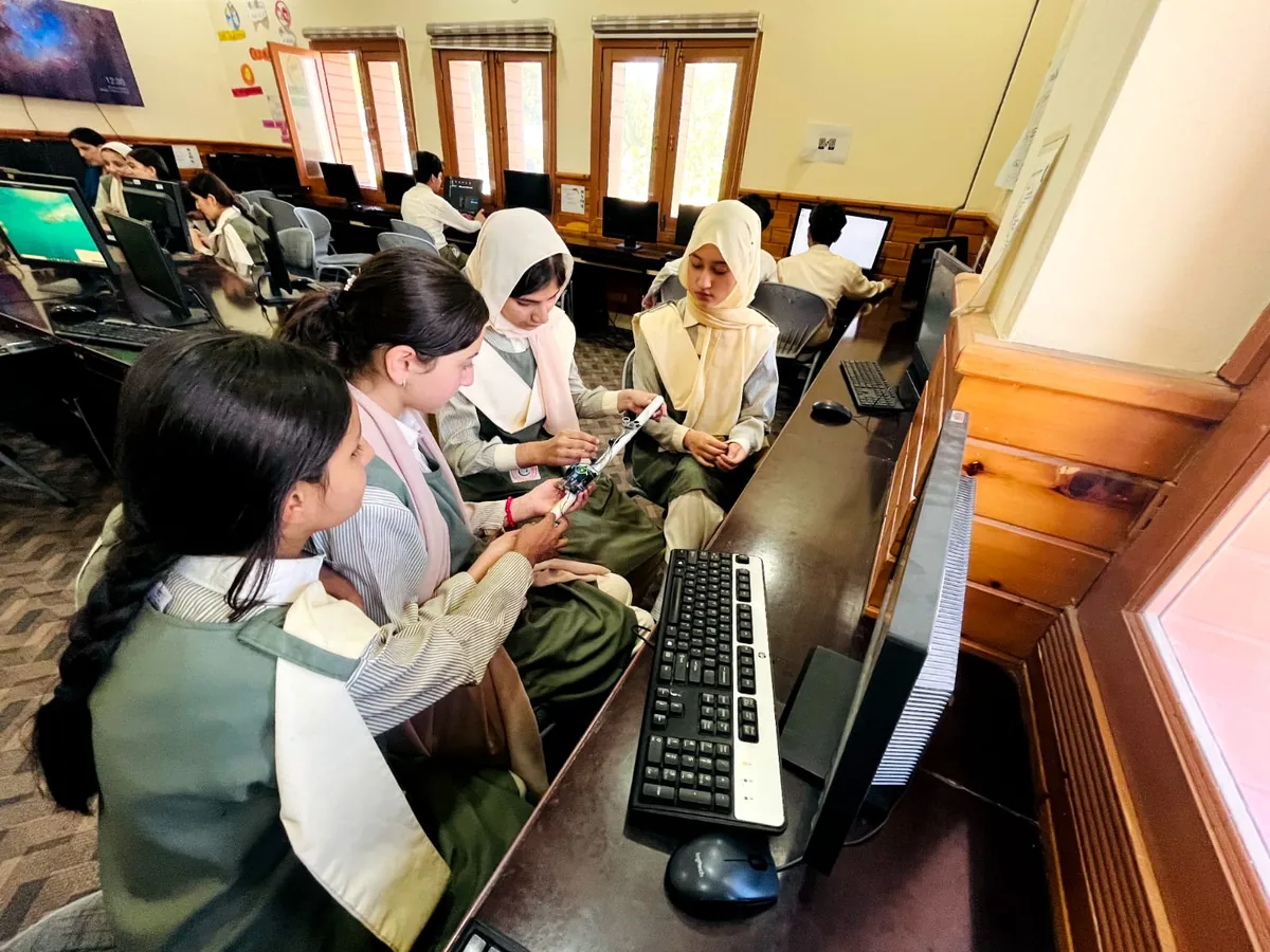 Students testing a circuit together in the lab