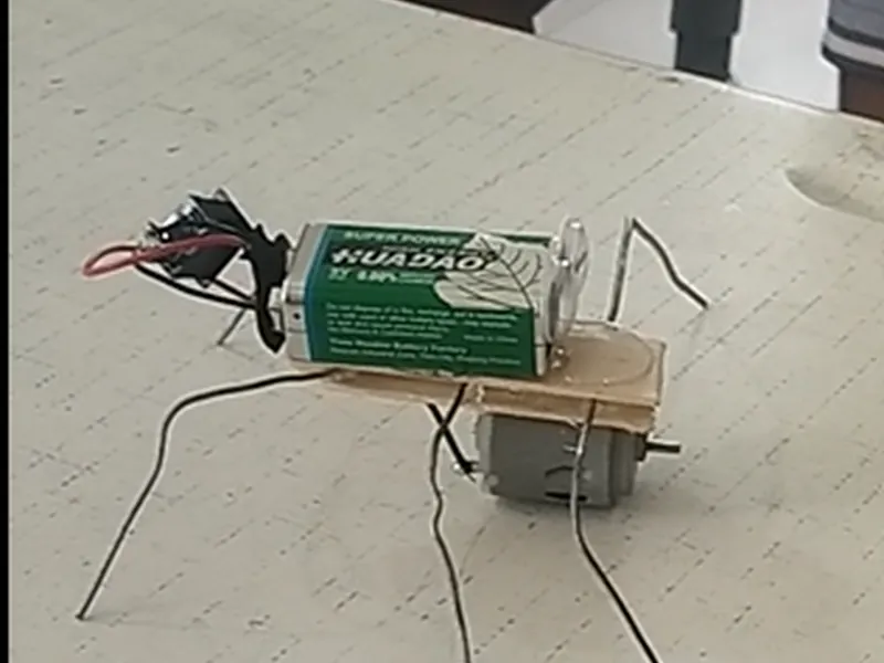 A spider bot made by students from a motor, battery and wire legs