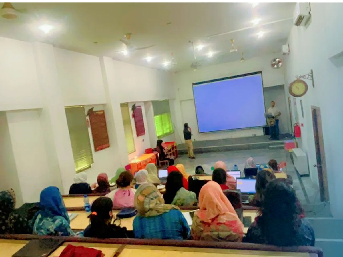A large group of teachers in an AITEP session in a school hall