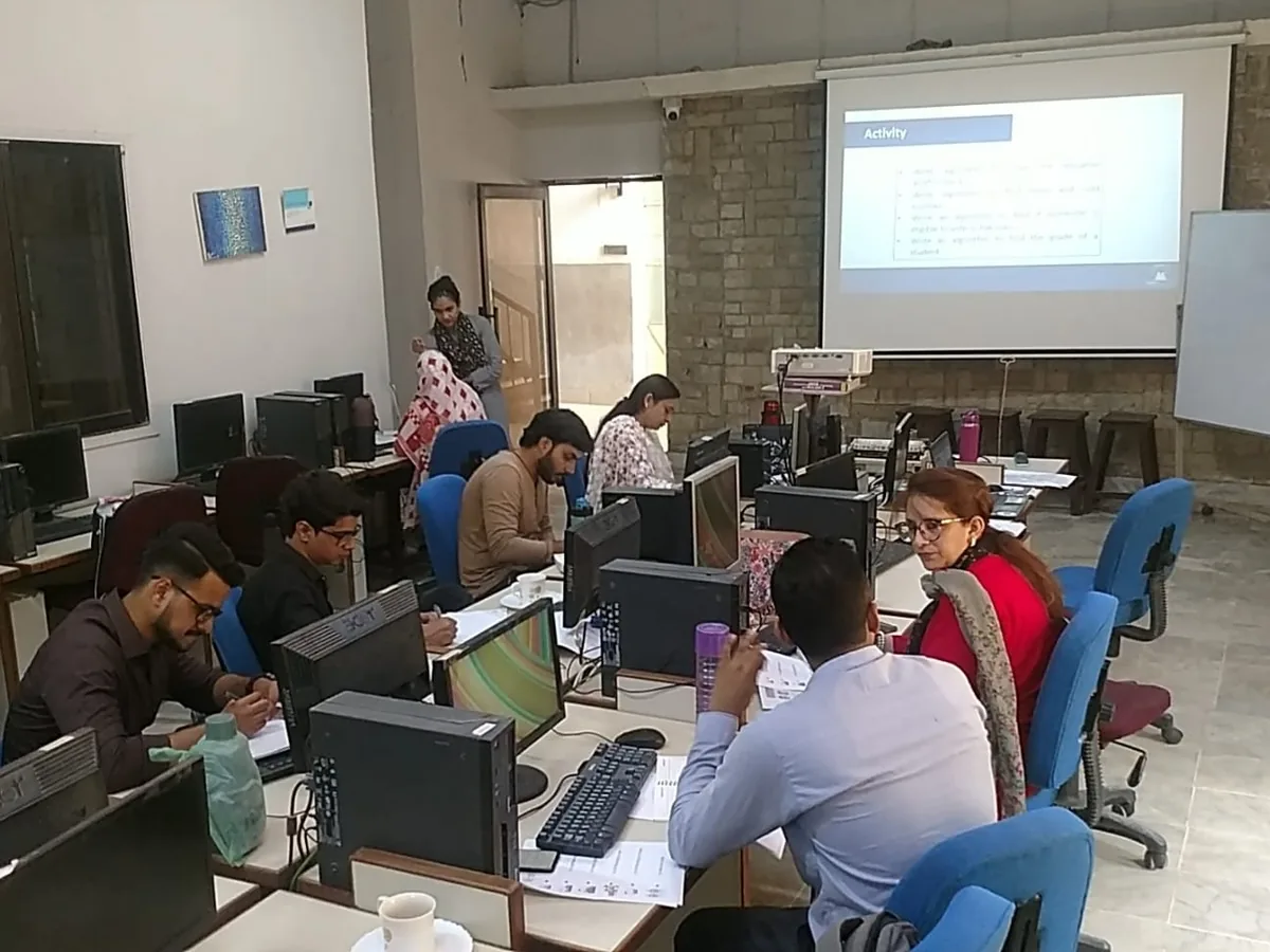 Teachers working on computers during an AITEP session