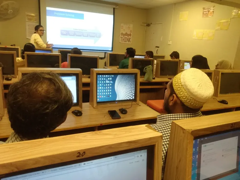 Teachers practising with AI tools on computers